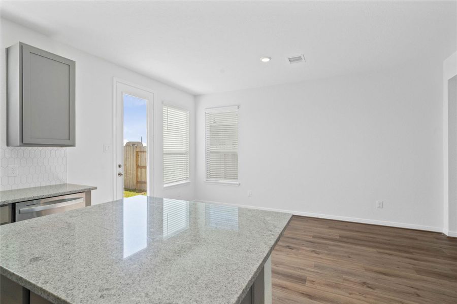 Additional view of the kitchen highlighting the granite countertops and nook!