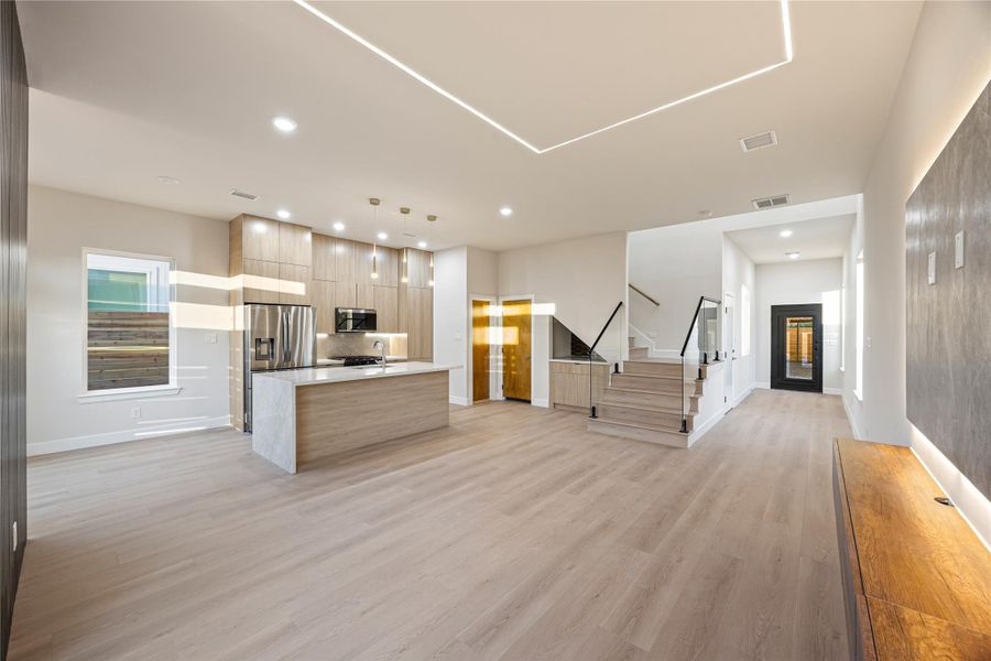 Alternate angle of wide entrance leading into living room and kitchen area.