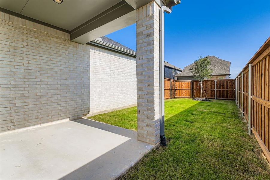 Fenced backyard with a patio area