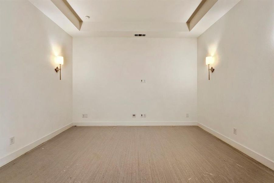 Empty room with a raised ceiling and baseboards