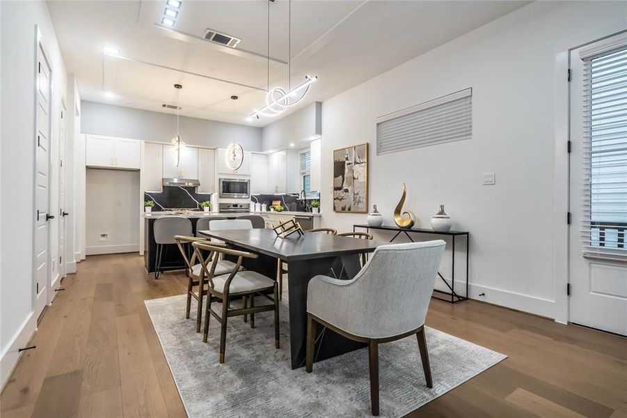 Corner view of the dining area showcasing a beautiful chandelier.