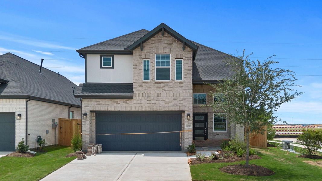 Front exterior of a new home in Jordan Ranch, Fulshear, TX, highlighting curb appeal (Image 21). Front exterior of a new home in Jordan Ranch, Fulshear, TX, highlighting curb appeal (Image 21).
