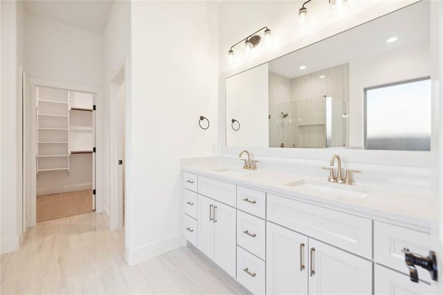 Bathroom featuring vanity and a shower with shower door