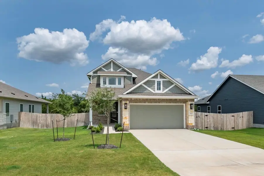 Front exterior of a new home in Grande Estates, Bertram, TX, highlighting curb appeal (Image 2). Front exterior of a new home in Grande Estates, Bertram, TX, highlighting curb appeal (Image 2).