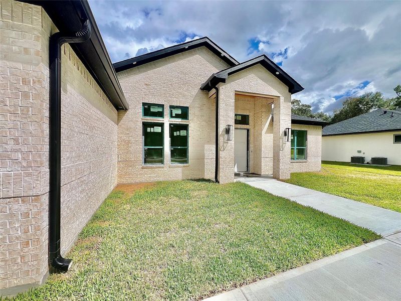 Front exterior of a new home in , Dayton, TX, highlighting curb appeal (Image 5).
