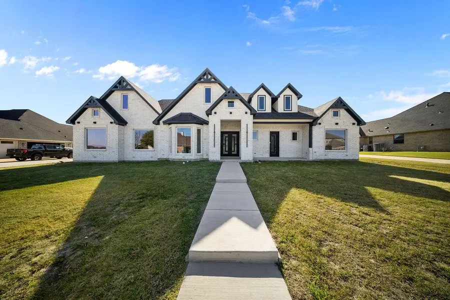 View of front of house with brick siding and a front yard