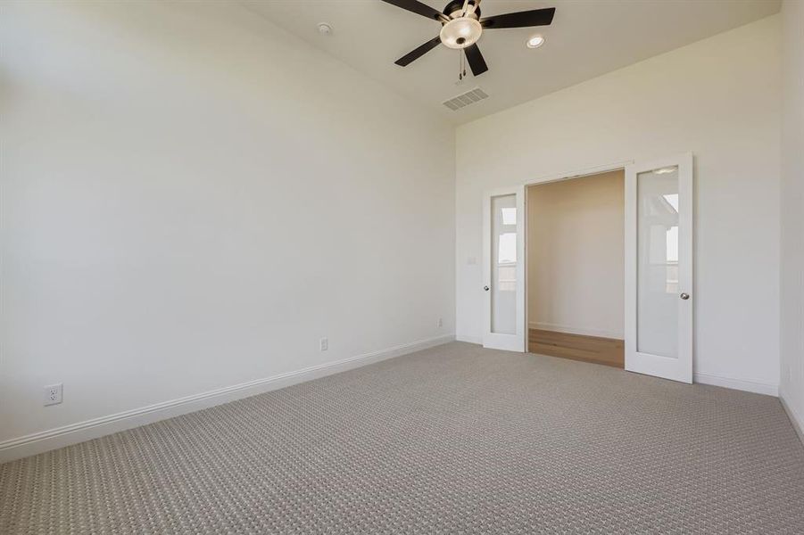 Empty room featuring carpet, recessed lighting, and a ceiling fan