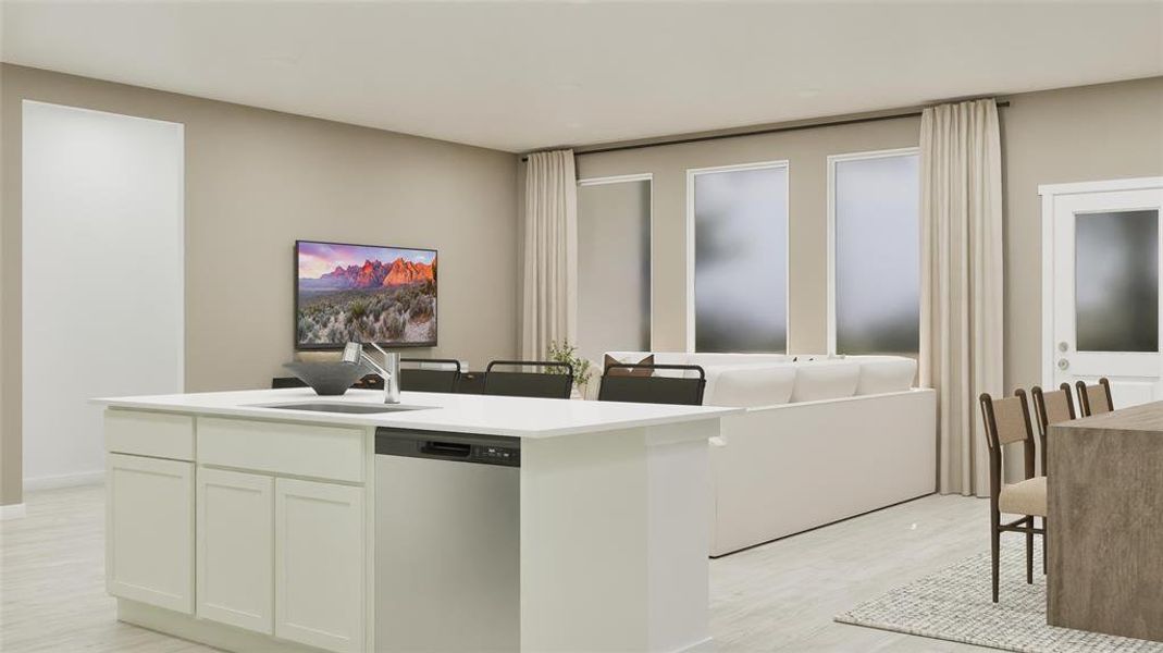 Kitchen with stainless steel dishwasher, white cabinets, an island with sink, and light stone countertops