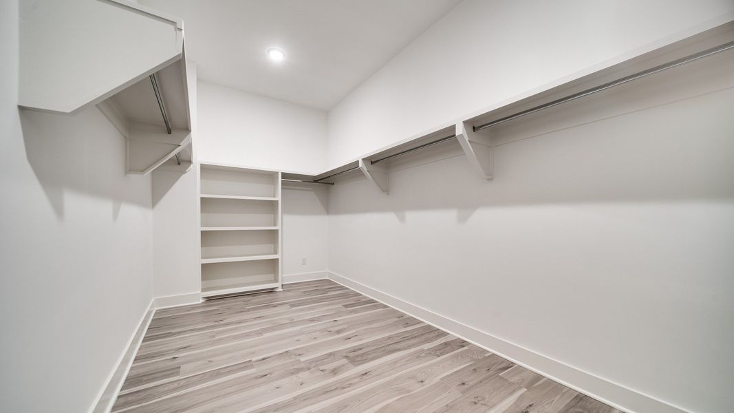 Large walk-in closet showing built-in shelving
