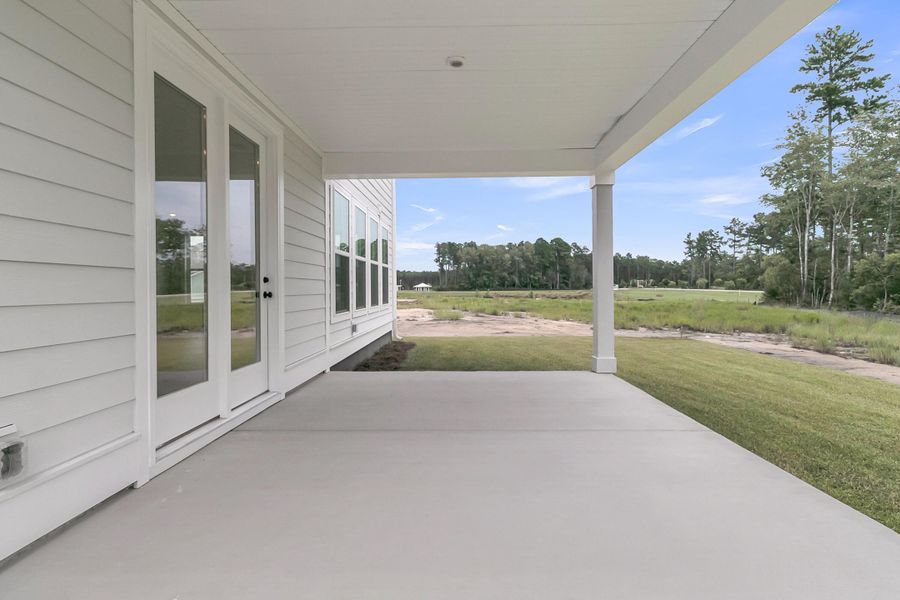 Exterior details and patio area of a home in Tidewater at Lakes of Cane Bay, Summerville (Image 29).