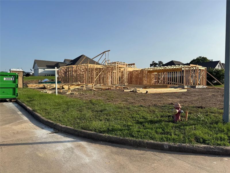 Street-level view of active construction at 1707 Twin Oaks Circle. Home is currently under construction with completion anticipated in mid-October.