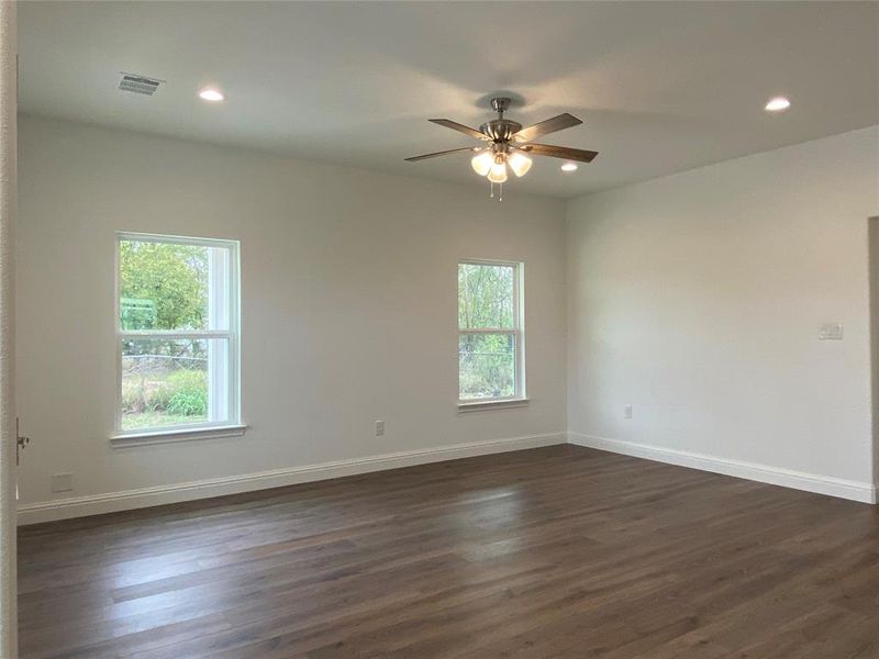 Living room with dark wood-style floors, recessed lighting, and ceiling fan Living room with dark wood-style floors, recessed lighting, and ceiling fan