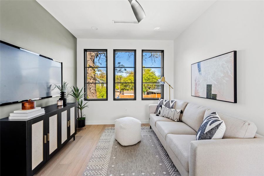 Living area with light wood-type flooring and baseboards
