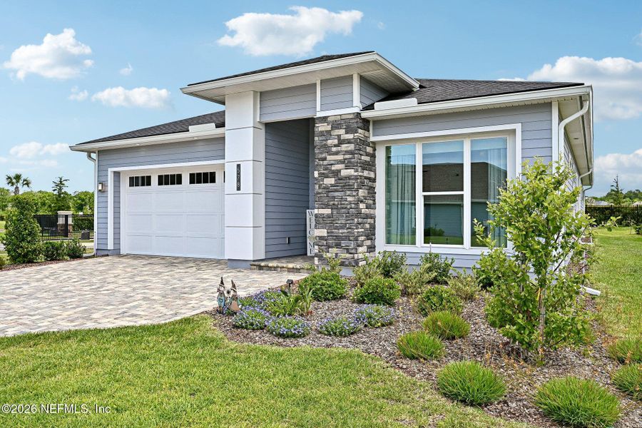 Front exterior of a new home in SilverLeaf, St. Augustine, FL, highlighting curb appeal (Image 30). Front exterior of a new home in SilverLeaf, St. Augustine, FL, highlighting curb appeal (Image 30).