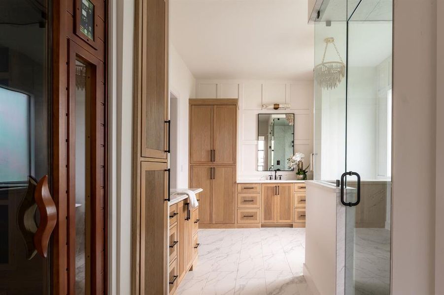 Full bathroom with vanity, light marble finish flooring, and a marble finish shower Full bathroom with vanity, light marble finish flooring, and a marble finish shower