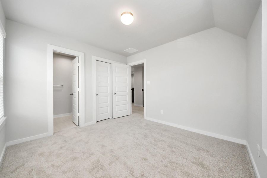 Generously sized secondary bedrooms featuring spacious closets, soft and inviting carpeting underfoot, large windows allowing plenty of natural light, and the added touch of privacy blinds for your personal retreat. Sample photo of completed home with similar floor plan. Actual colors and selections may vary.