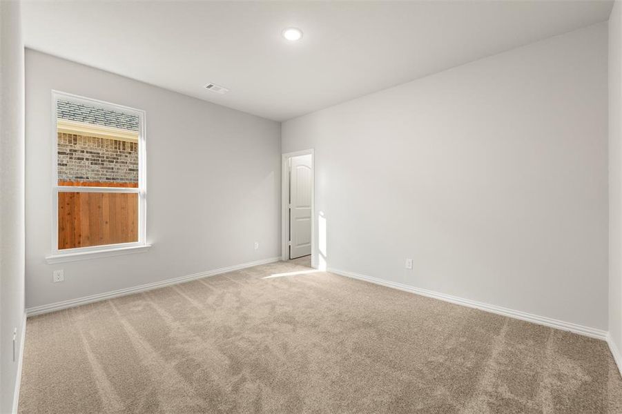 Carpeted spare room featuring baseboards and recessed lighting Carpeted spare room featuring baseboards and recessed lighting