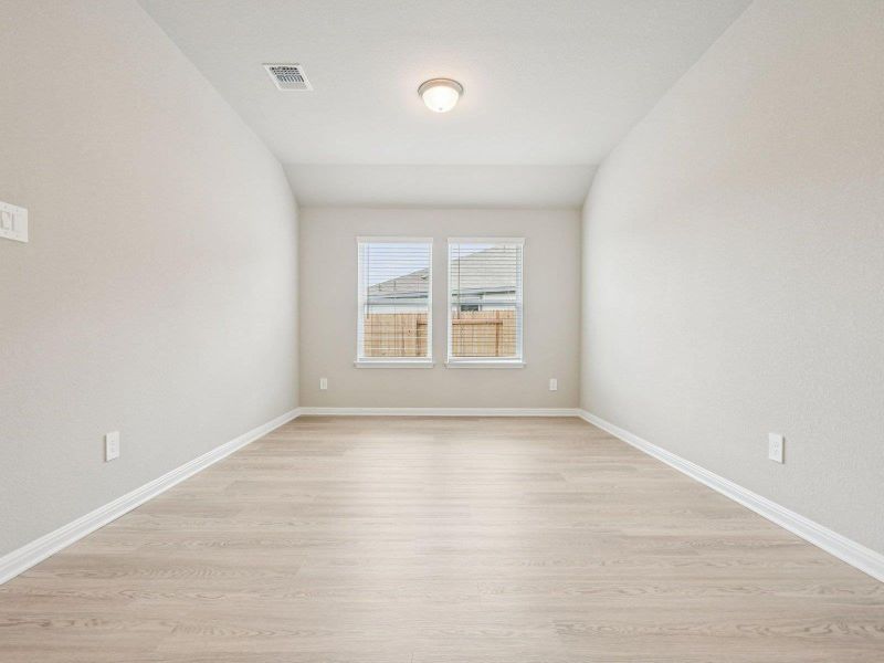 Empty room featuring light wood-style floors and vaulted ceiling Empty room featuring light wood-style floors and vaulted ceiling