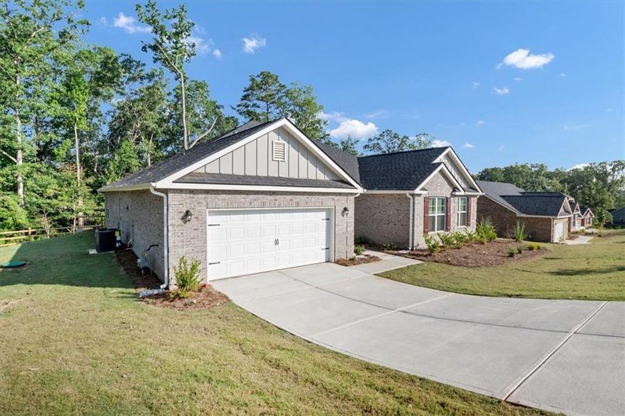 Front exterior of a new home in Tuscany Hills, Douglasville, GA, highlighting curb appeal (Image 21).