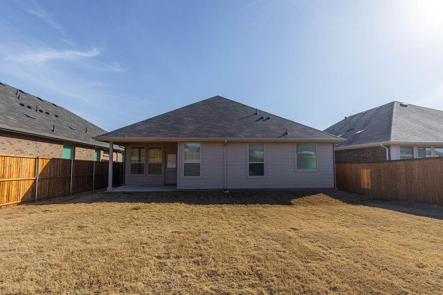 Rear view of property featuring a patio area and a fenced backyard Rear view of property featuring a patio area and a fenced backyard
