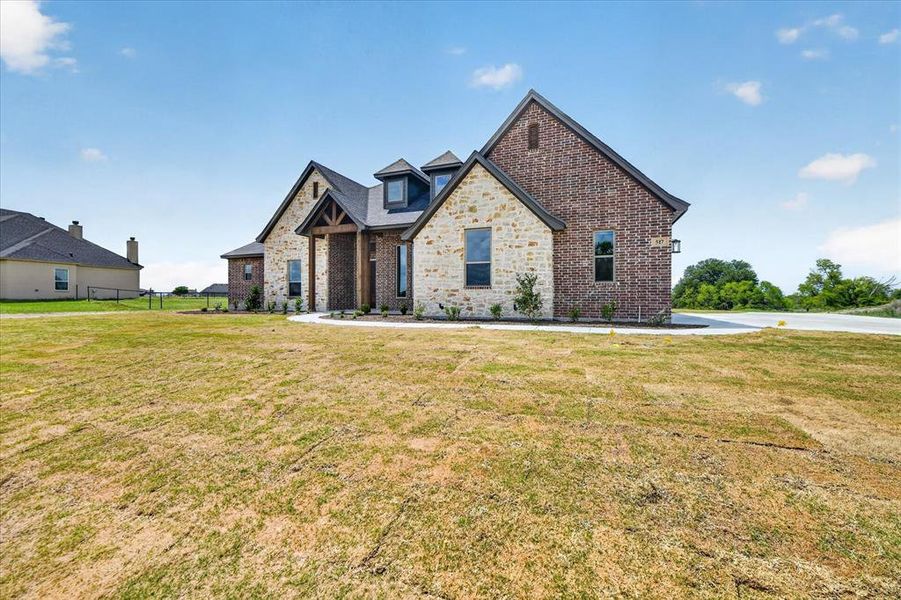 View of front of property featuring brick siding and stone siding
