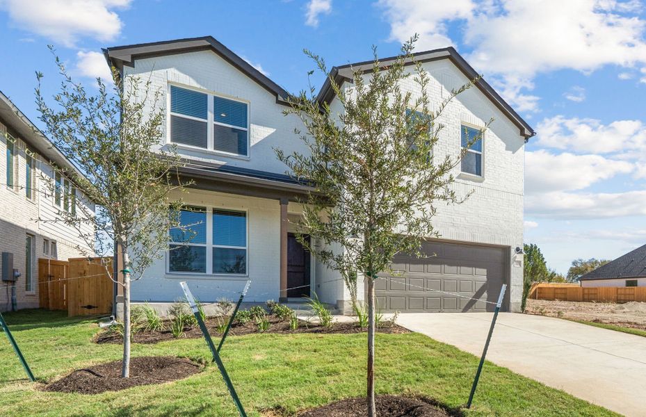 Front exterior of a new home in Woodside, Georgetown, TX, highlighting curb appeal (Image 24).