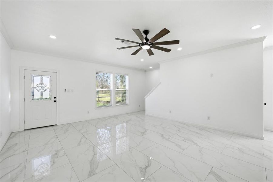 Entryway with ornamental molding, light marble finish floors, a ceiling fan, and recessed lighting Entryway with ornamental molding, light marble finish floors, a ceiling fan, and recessed lighting