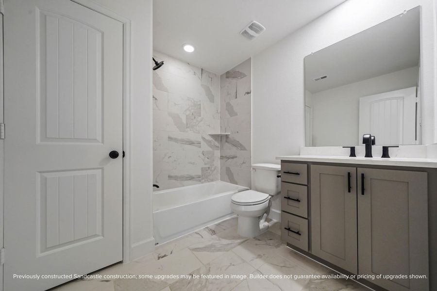 With its bold contrast and modern textures, this secondary bath adds a splash of luxury to your daily routine. (Model home shown; finishes may vary.)