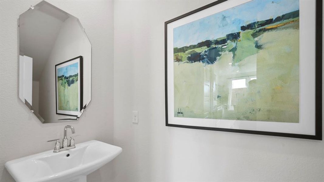 Bathroom featuring a sink and a marble finish shower