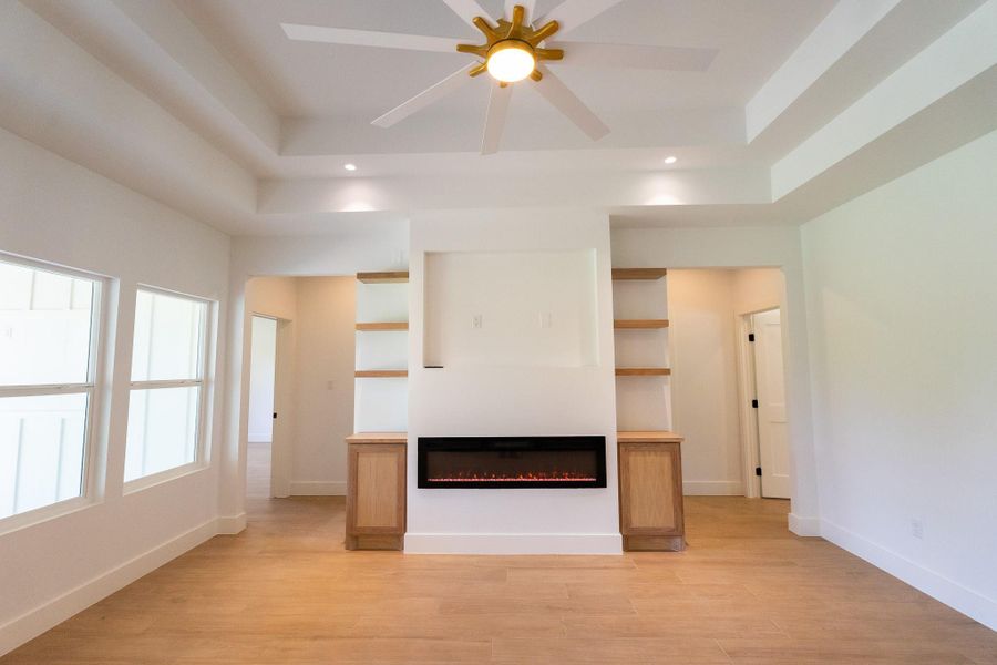The living room has a built-in electric fireplace