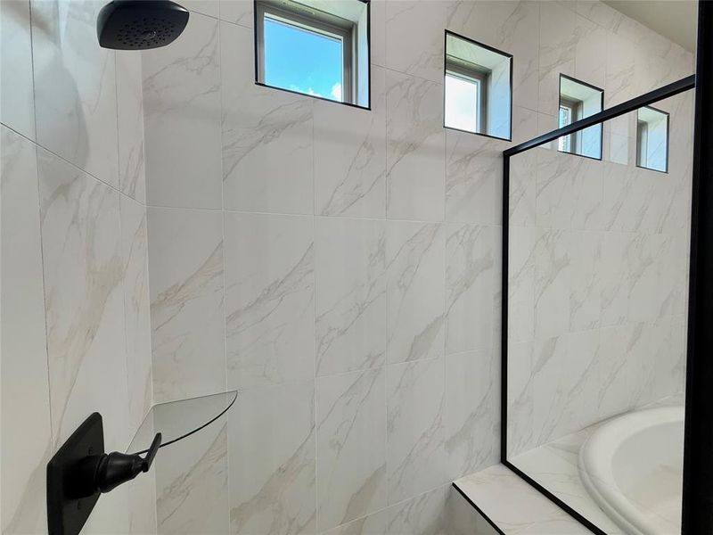 Full bath featuring a tile shower