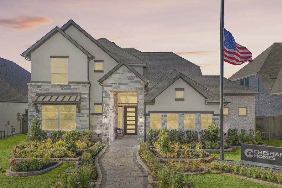 Front exterior of a new home in Riceland 60',65',70', Mont Belvieu, TX, highlighting curb appeal (Image 2). Front exterior of a new home in Riceland 60',65',70', Mont Belvieu, TX, highlighting curb appeal (Image 2).