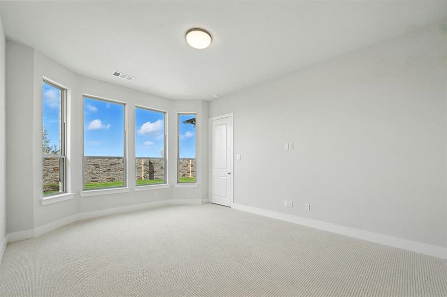 Carpeted spare room featuring baseboards Carpeted spare room featuring baseboards