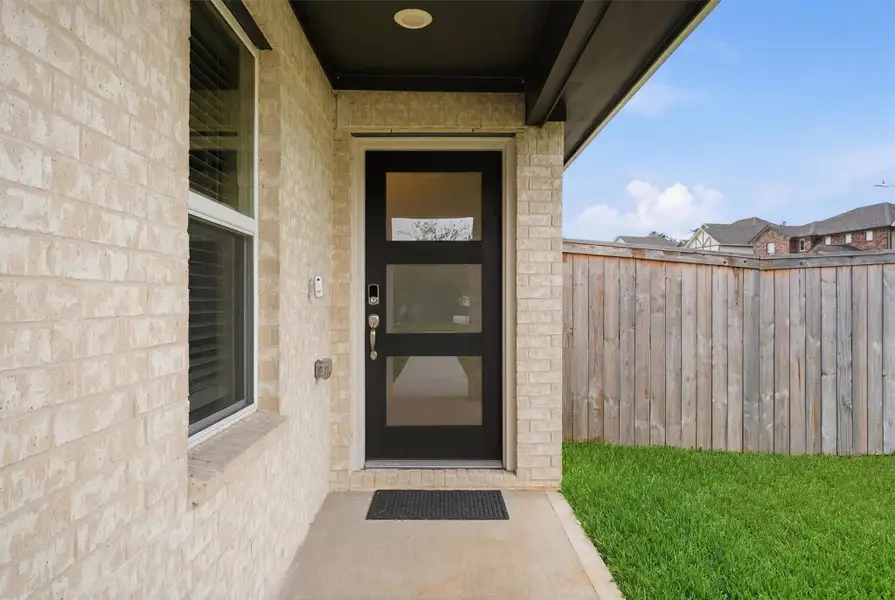 Covered front porch with beautiful accents like this stylish front door with bright led lighting for safety. Covered front porch with beautiful accents like this stylish front door with bright led lighting for safety.