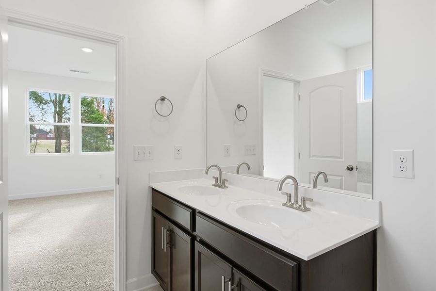 A bathroom with a large mirror. A bathroom with a large mirror.