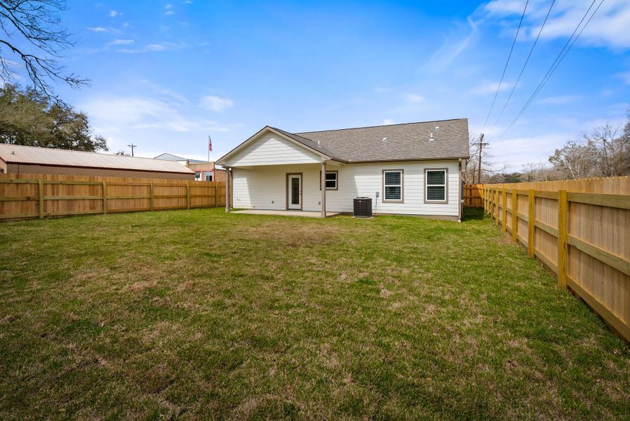 Rear view of property featuring a patio and a fenced backyard