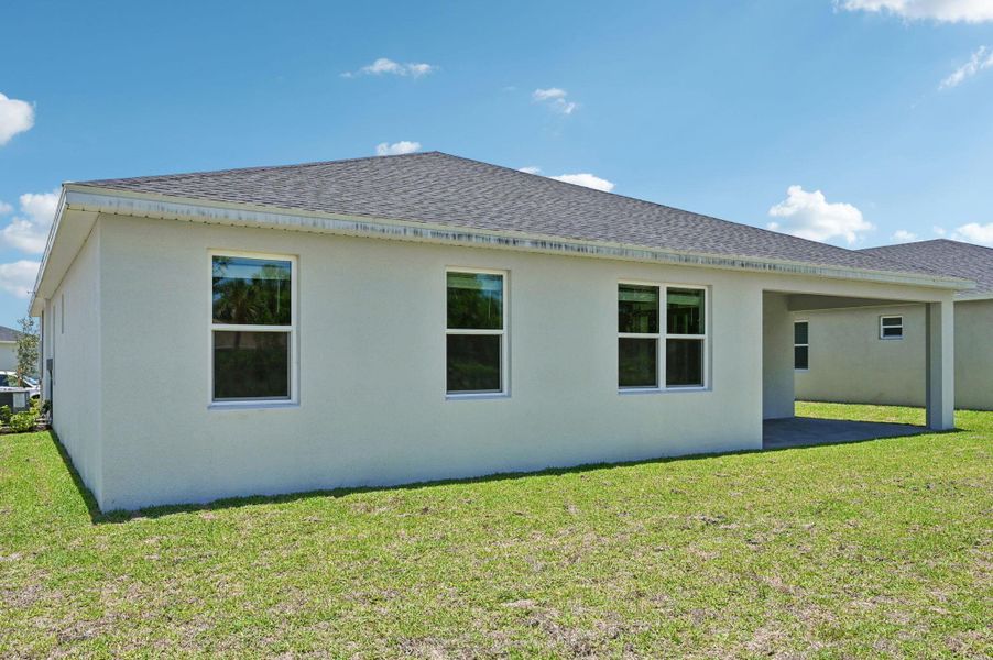 Front exterior of a new home in Hampton Park - Signature Series, Vero Beach, FL, highlighting curb appeal (Image 17).