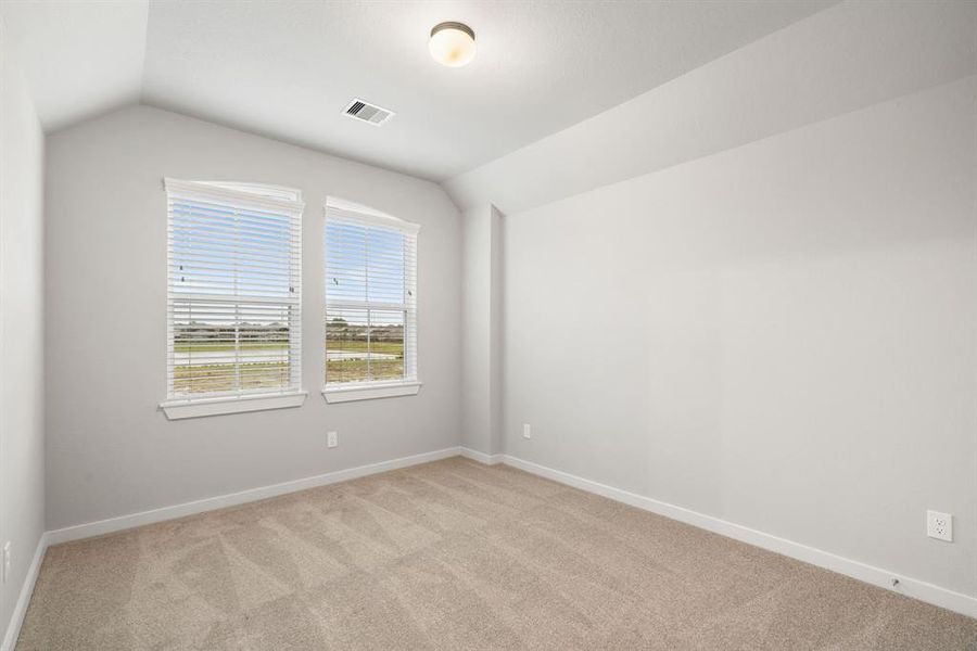 Generously sized secondary bedrooms, showcasing 5-panel doors with modern hardware, large windows adorned with privacy blinds, and spacious closets boasting sleek and contemporary finishesRepresentation. Actual color and selections can vary.