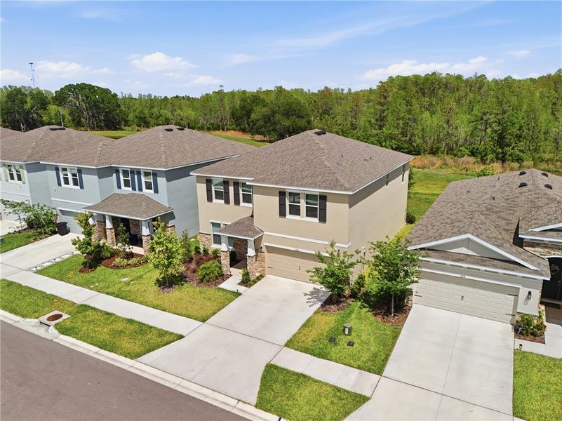 Front exterior of a new home in Deerbrook, Land O' Lakes, FL, highlighting curb appeal (Image 30).