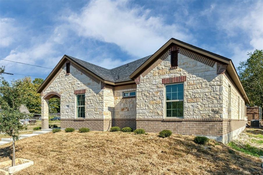 French country inspired facade with stone siding French country inspired facade with stone siding