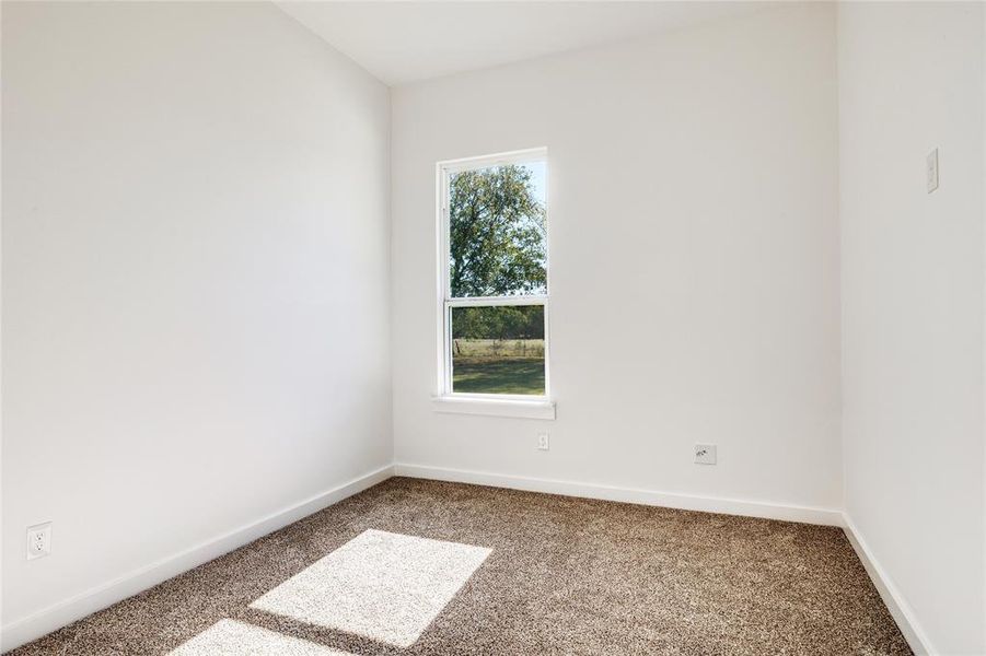 Spare room with carpet and baseboards