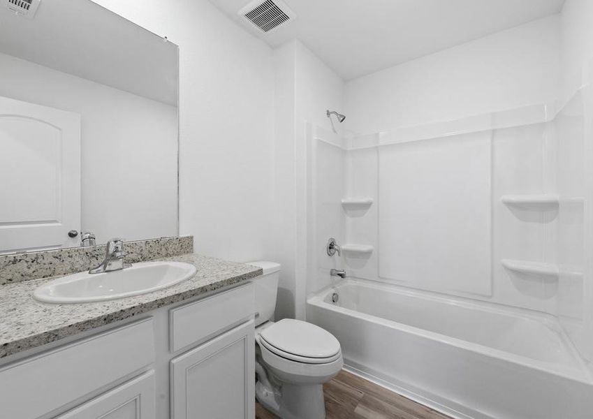 Secondary bathroom with grey granite countertops