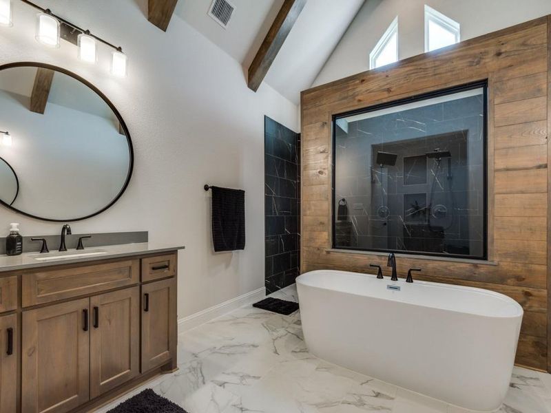 Bathroom with vaulted ceiling with beams, independent shower and bath, and vanity