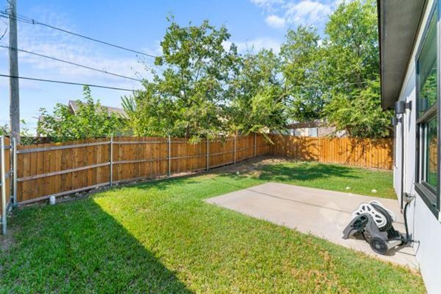 Fenced backyard with a patio area Fenced backyard with a patio area