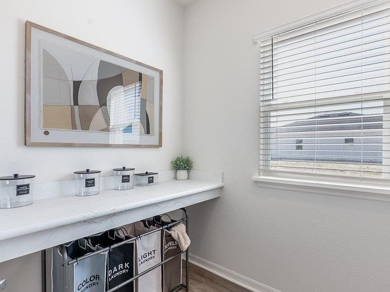 A counter in the laundry room is perfect for sorting and folding - Monroe by Highland Homes A counter in the laundry room is perfect for sorting and folding - Monroe by Highland Homes