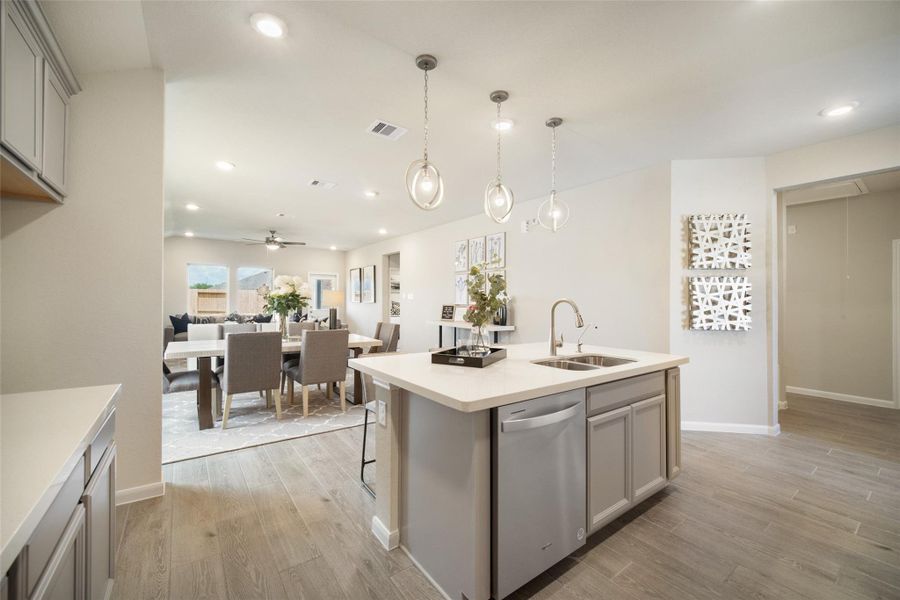 All this opens up to the expansive family room, creating a perfect hub for gatherings. Sample photo of completed home with similar floor plan. Actual colors and selections may vary.