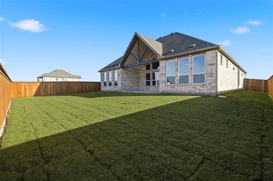 Back of house featuring a fenced backyard, brick siding, and a patio area Back of house featuring a fenced backyard, brick siding, and a patio area