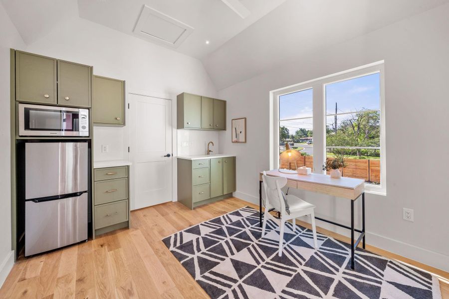 Detached bonus space features refrigerator, sink, and multi-oven.