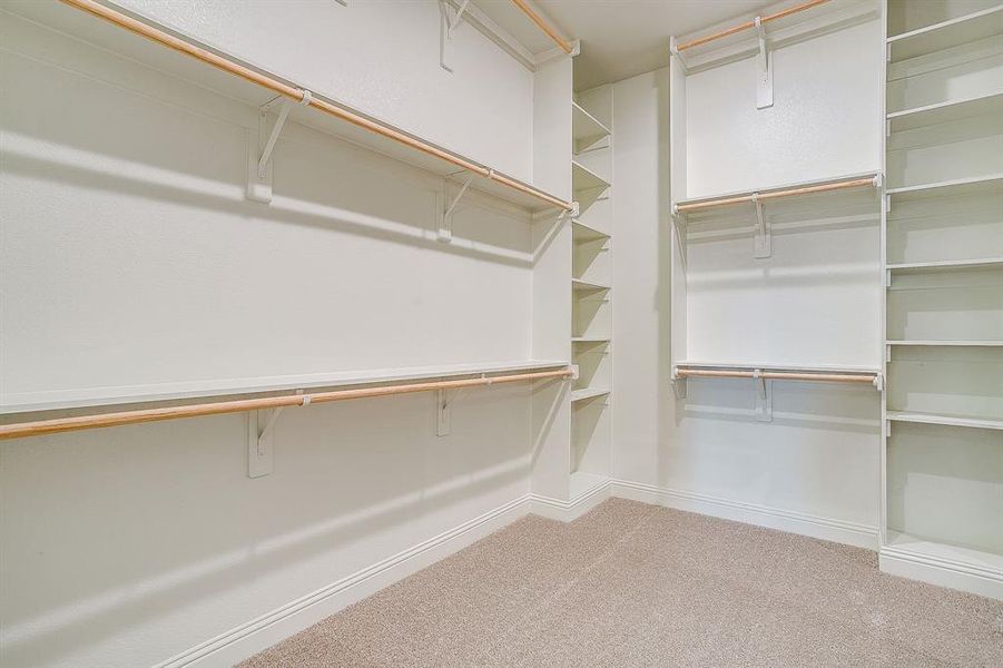 Walk in closet in primary bedroom