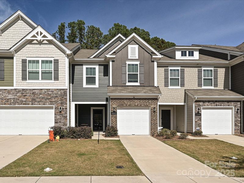 Front exterior of a new home in , Matthews, NC, highlighting curb appeal (Image 1).